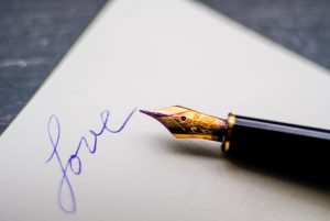 pen with love letter on paper