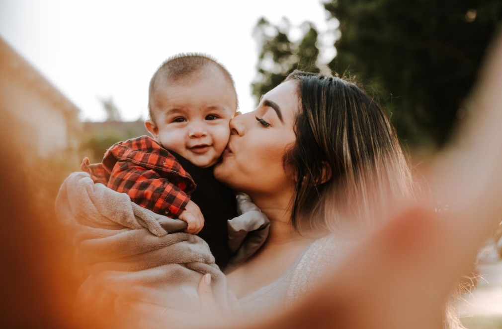 mother kiss her baby