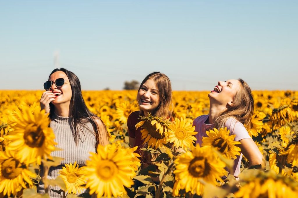 3 happy girls in sunflower fields
